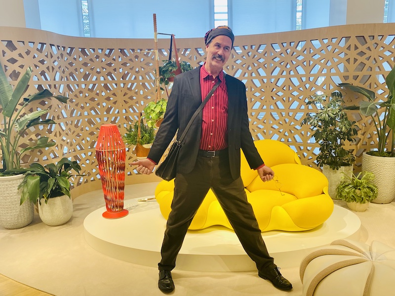 Krist posing w/ modern colorful furniture.