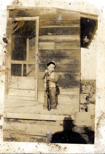 Vintage image child w/ rifle.