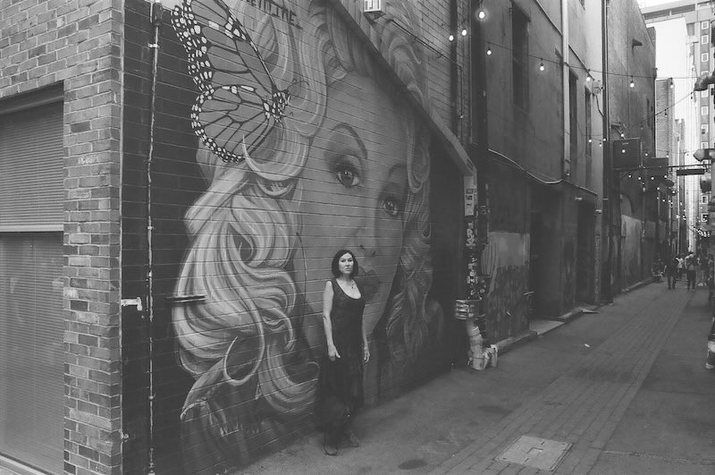 Darka in front of Dolly Parton mural.